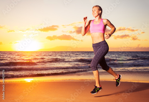 Fitness woman running at sunset