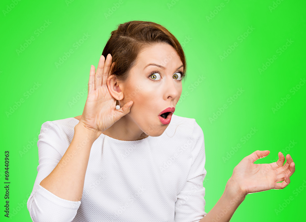 Nosy surprised woman hand to ear gesture, carefully listens