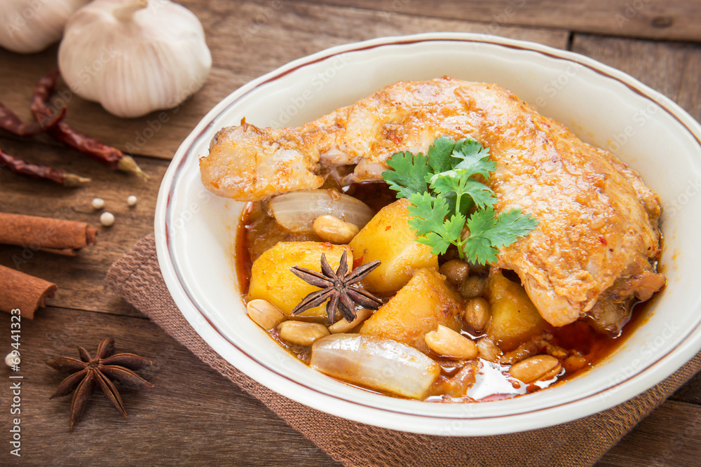 Chicken mussaman curry in bowl and herb Chicken mussaman curry in bowl and herb