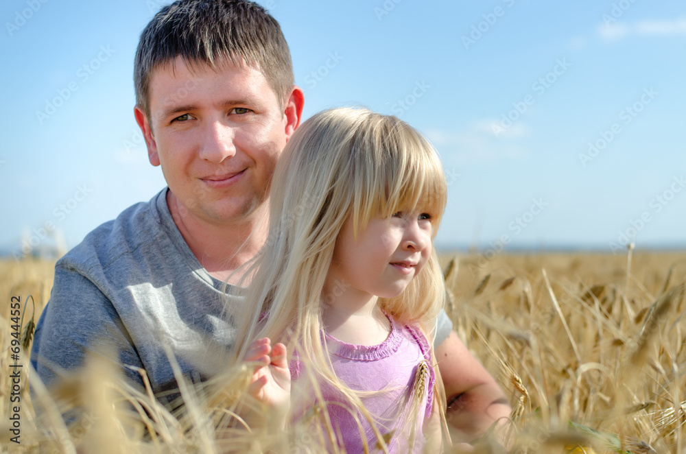 Cute little girl with her father in a wheat field Cute little girl with her father in a wheat field