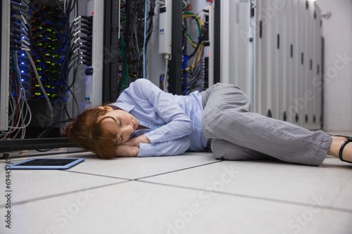 Exhausted technician sleeping on the floor