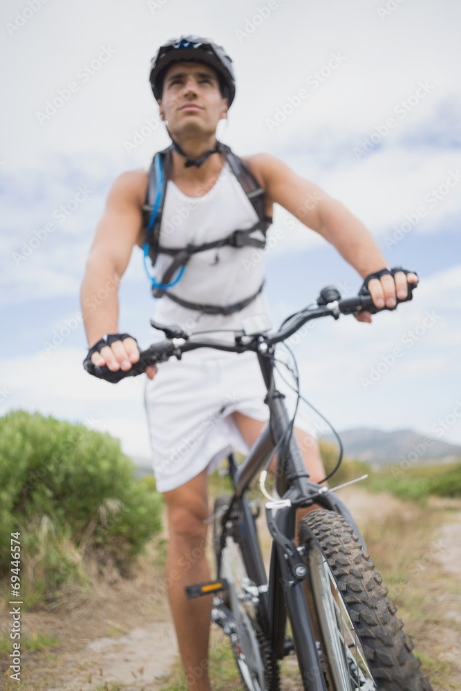 Fototapeta premium Athletic young man mountain biking