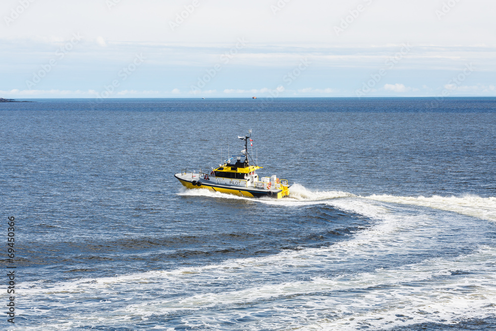 Fototapeta premium Yellow Pilot Boat Curving Through Water