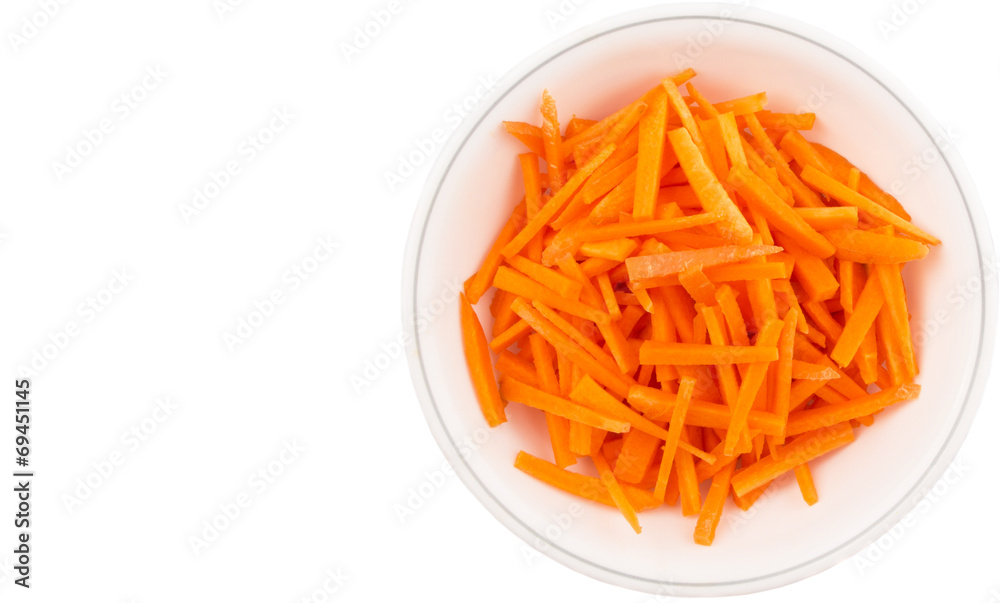 Chopped carrot in a bowl over white background Chopped carrot in a bowl over white background