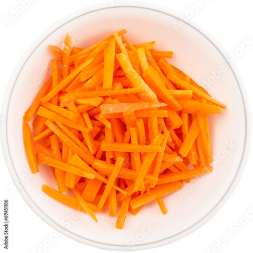 Chopped carrot in a bowl over white background