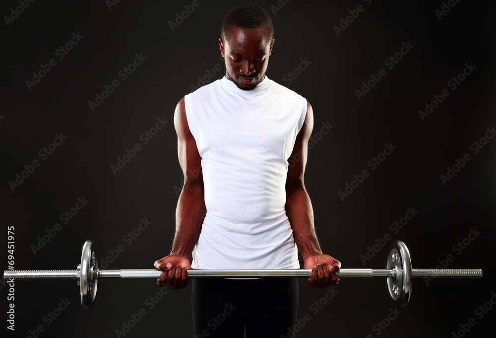 Young african man working out with barbell