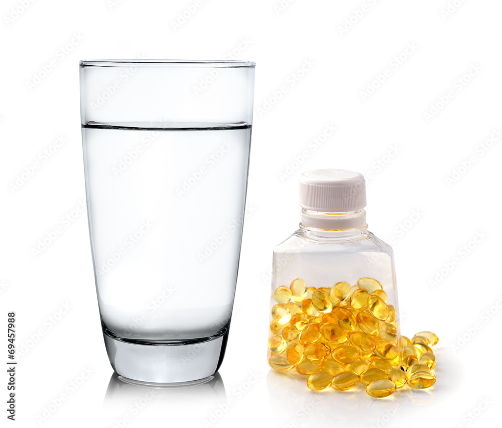 Glass of water and fish oil isolated on white background Glass of water and fish oil isolated on white background