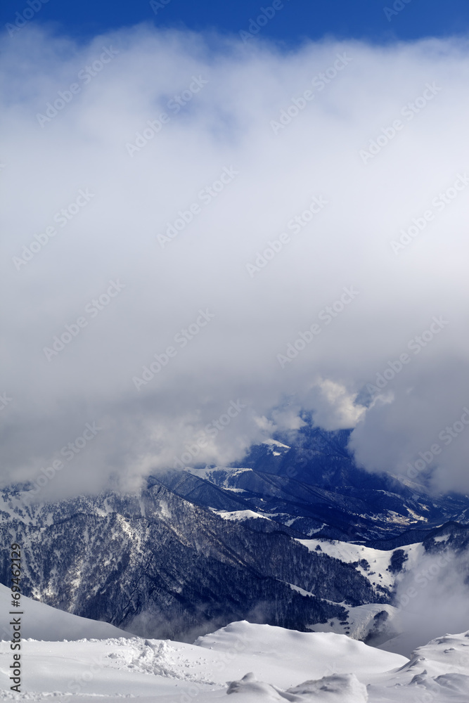 Winter snowy mountains in clouds Winter snowy mountains in clouds