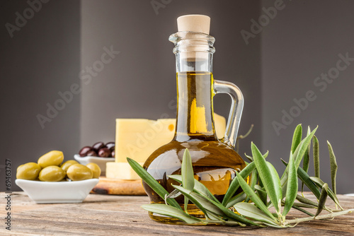 Fresh olives  oil rustic wooden background