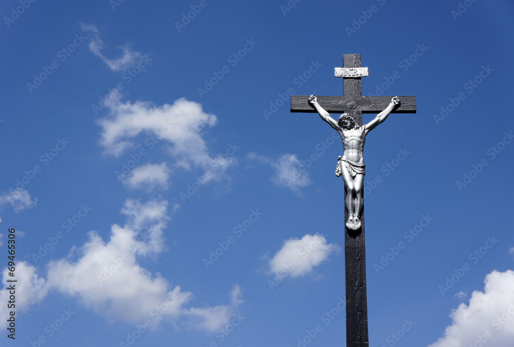 Jesus on the cross against a blue sky