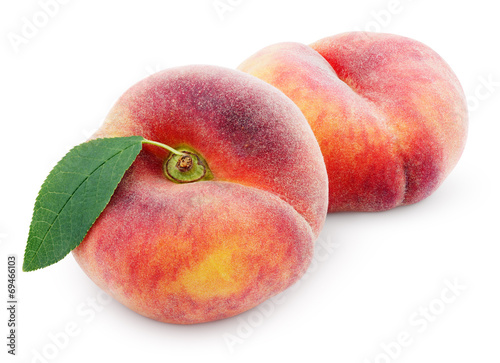Two chinese flat donut peaches with leaf isolated on white