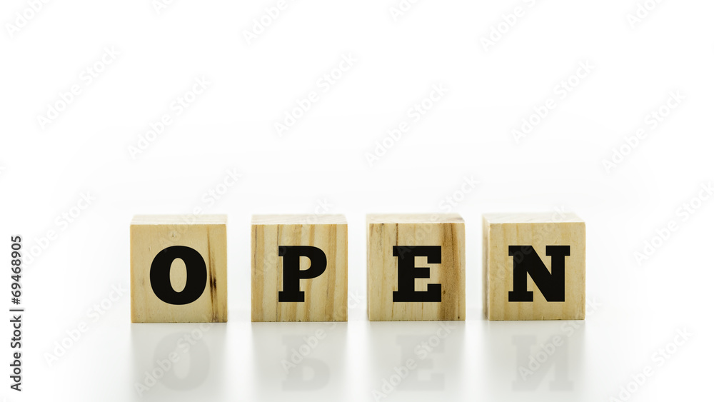 The word Open on four natural wooden cubes The word Open on four natural wooden cubes
