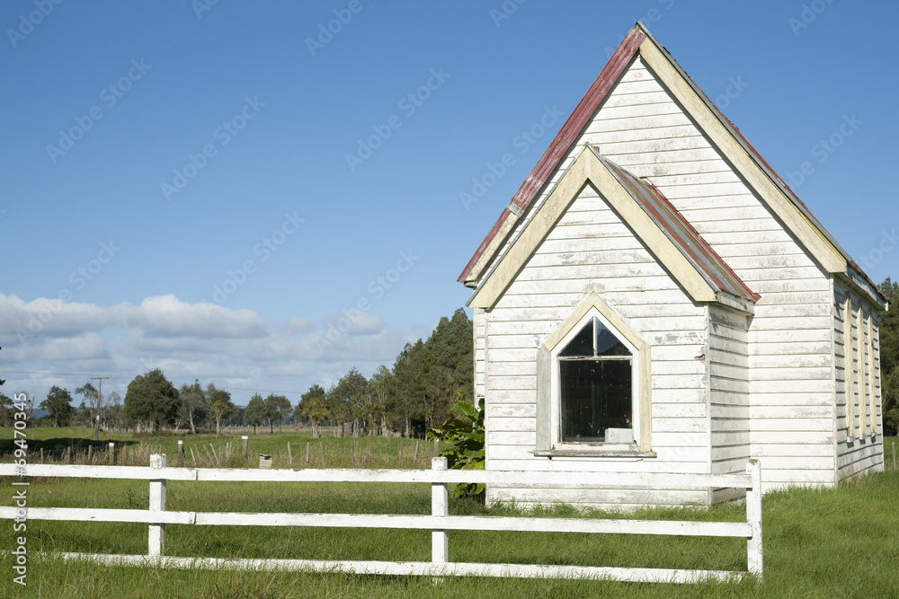 Small white church with white fence Small white church with white fence