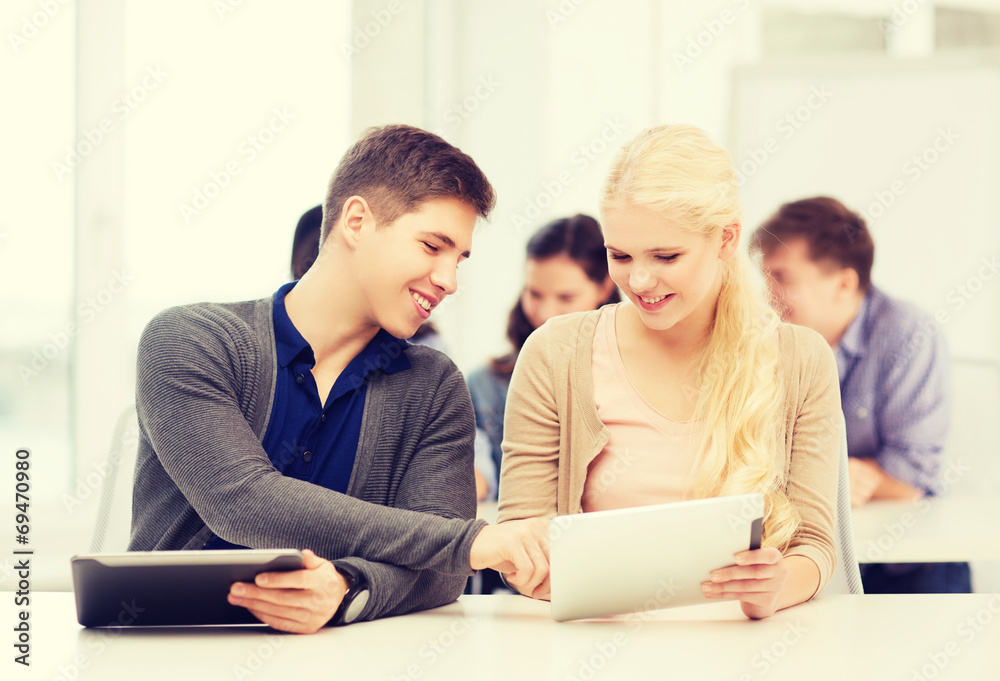 students looking at tablet pc in lecture at school students looking at tablet pc in lecture at school