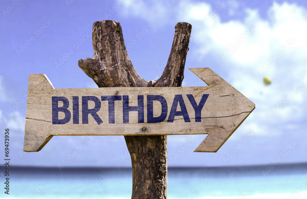 Birthday wooden sign with a beach on background