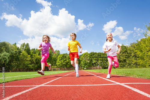 Smiling children running marathon together