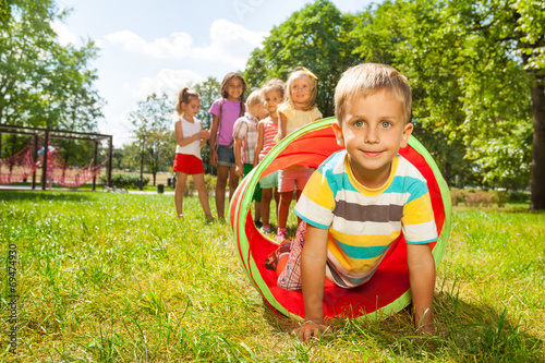 Playing crawling though tube on the lawn