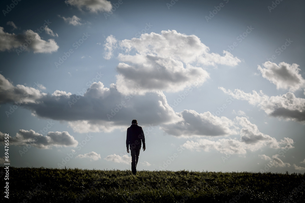Fototapeta premium lonely man walking in an empty landscape