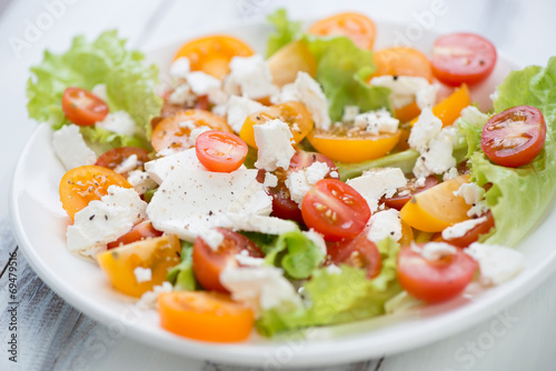 Vegetable salad with tomatoes and feta cheese, horizontal shot