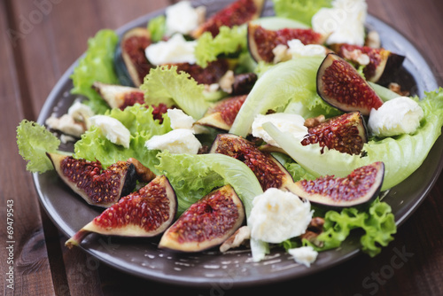 Fig fruits, cheese and walnuts salad, close-up, horizontal shot