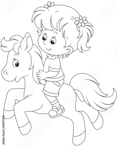 Little girl riding a pony