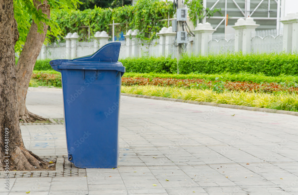 trash cans in the park beside the walk way trash cans in the park beside the walk way