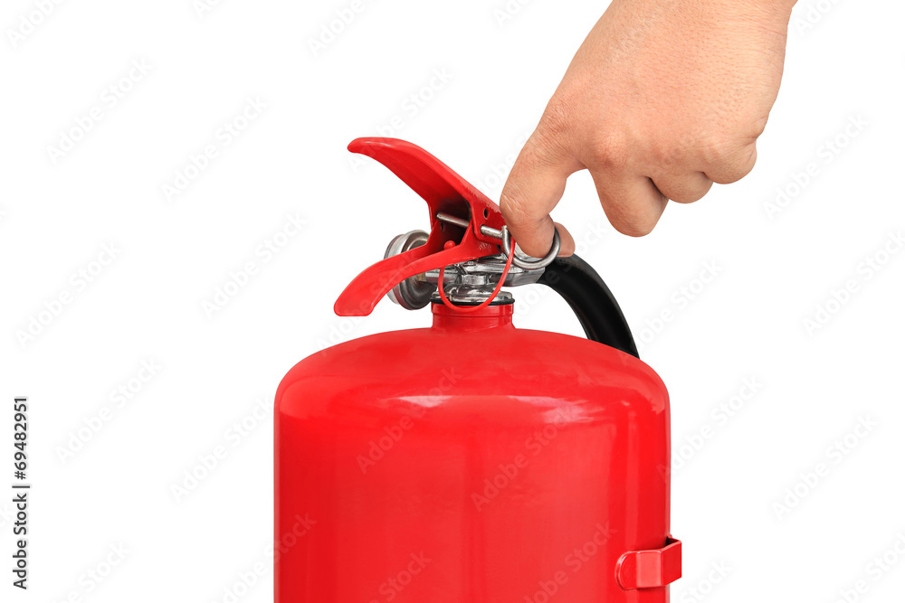 Hand pulling pin of fire extinguisher