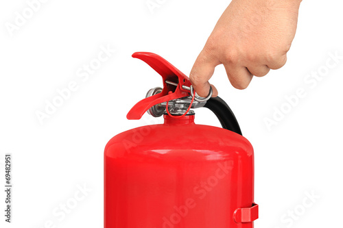 Hand pulling pin of fire extinguisher