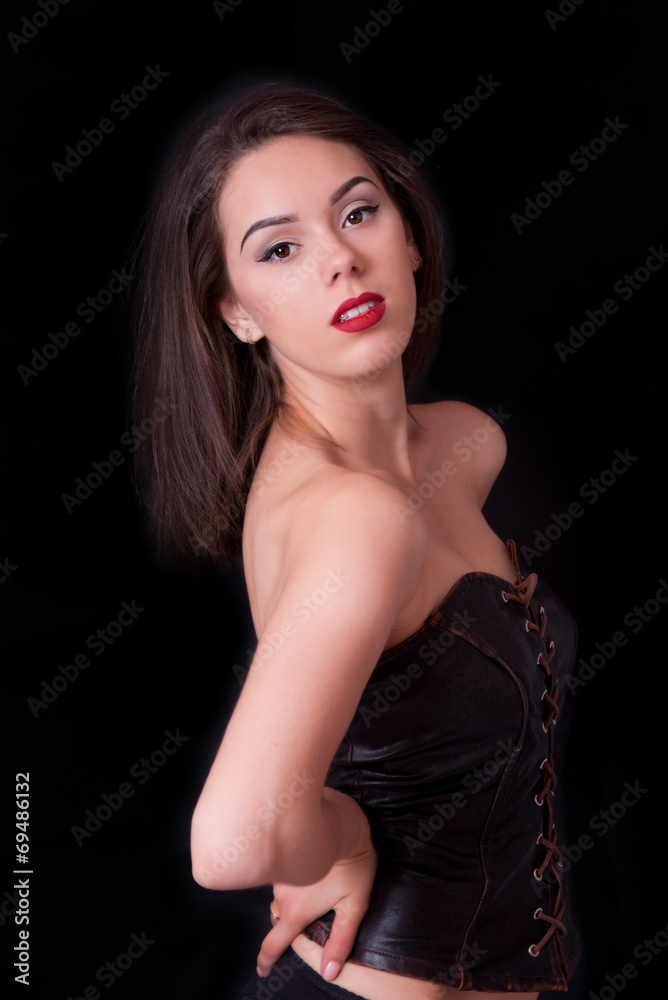 Attractive redhead woman on studio dark background