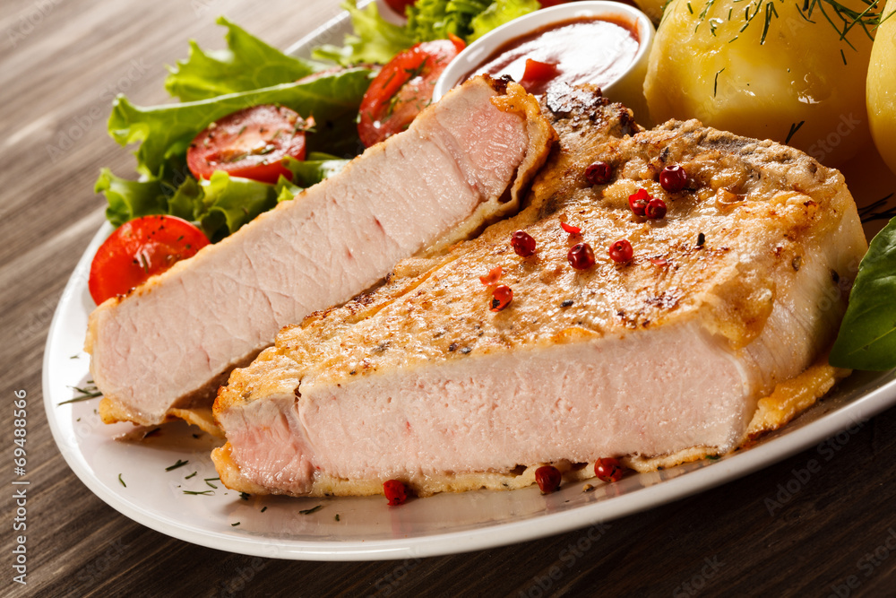 Fried pork chop, boiled potatoes and vegetable salad Fried pork chop, boiled potatoes and vegetable salad