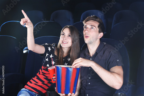 Young couple watching movie...