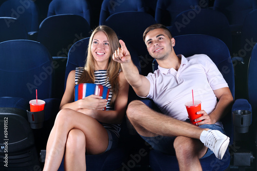 Young couple watching movie...