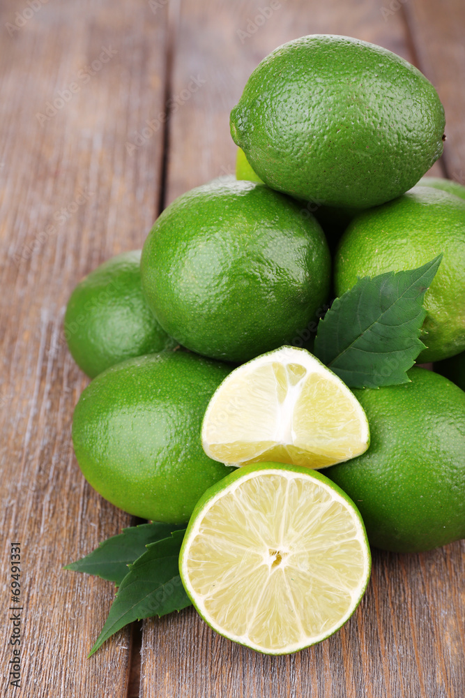 Fresh juicy limes on old wooden table Fresh juicy limes on old wooden table