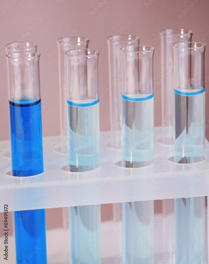Test tubes with liquid on grey background Test tubes with liquid on grey background