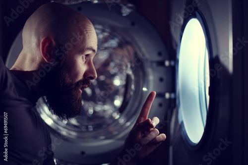 man next to a washing machine