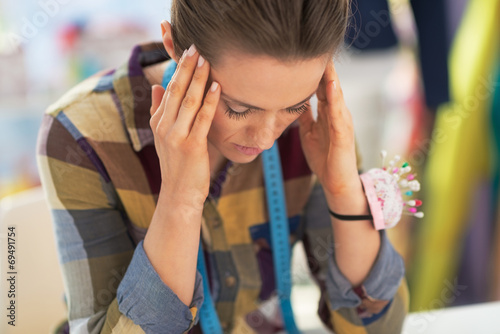 Photos Portrait of stressed tailor woman at work