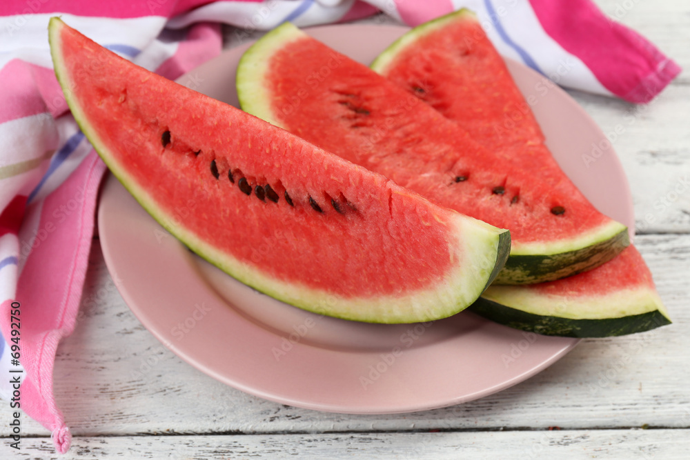 Fresh slice of watermelon on table outdoors, close up Fresh slice of watermelon on table outdoors, close up