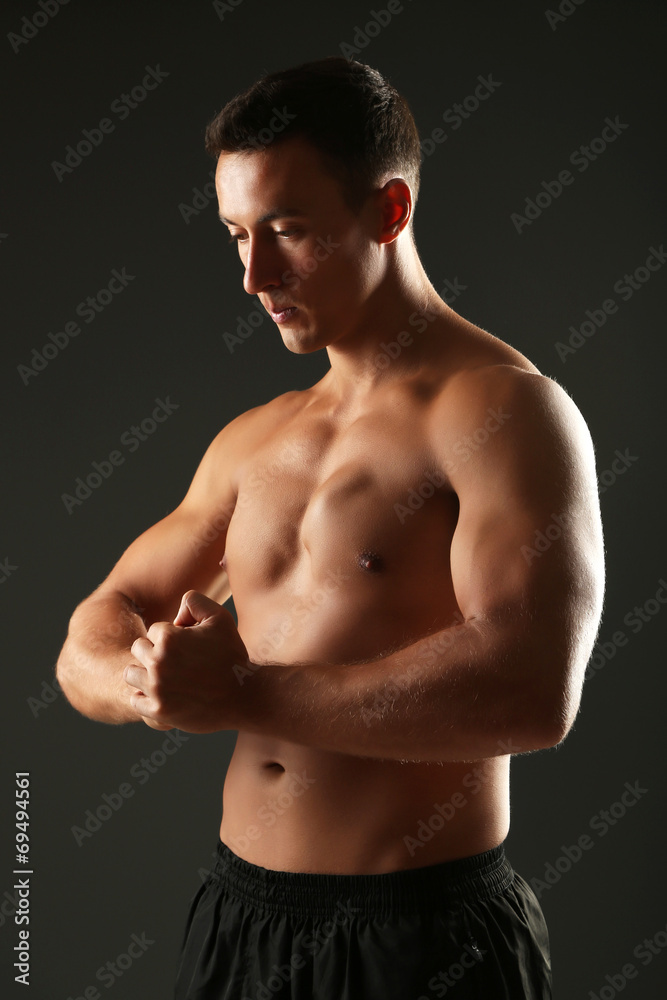 Handsome muscle young man on dark background Handsome muscle young man on dark background