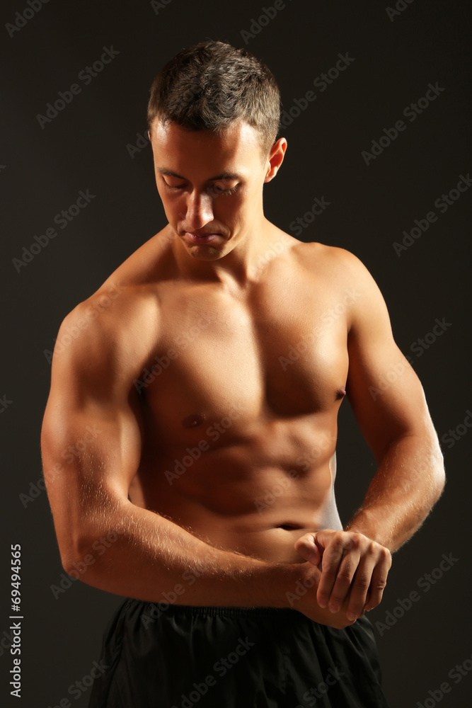 Handsome muscle young man on dark background