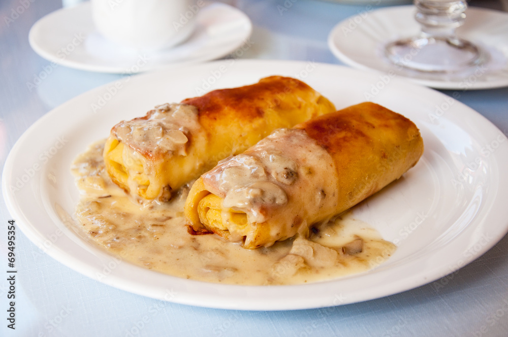 Pancakes with meat and mushroom sauce