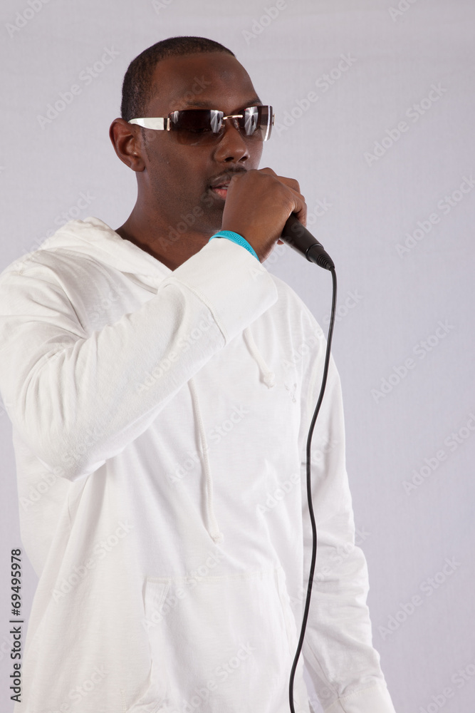 black man singing into a micdrophone black man singing into a micdrophone