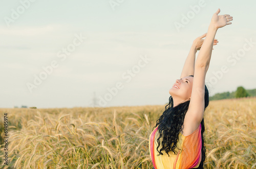 beautiful woman standing on wheat field