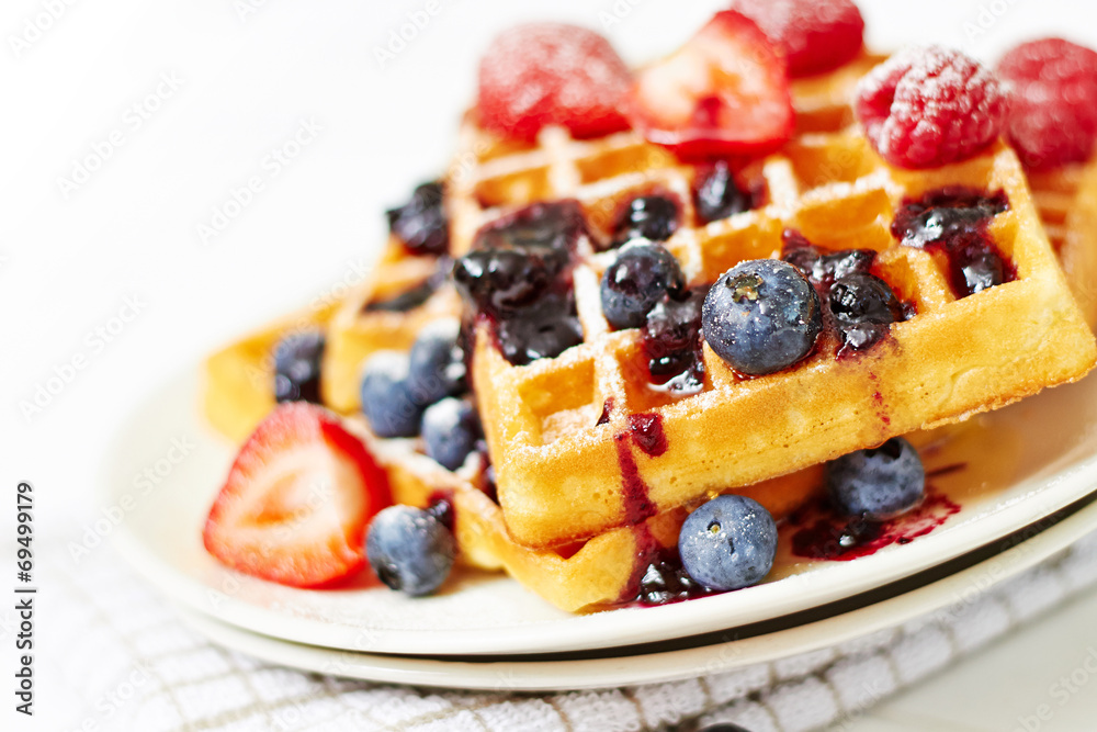 Golden waffles on white wooden table Golden waffles on white wooden table