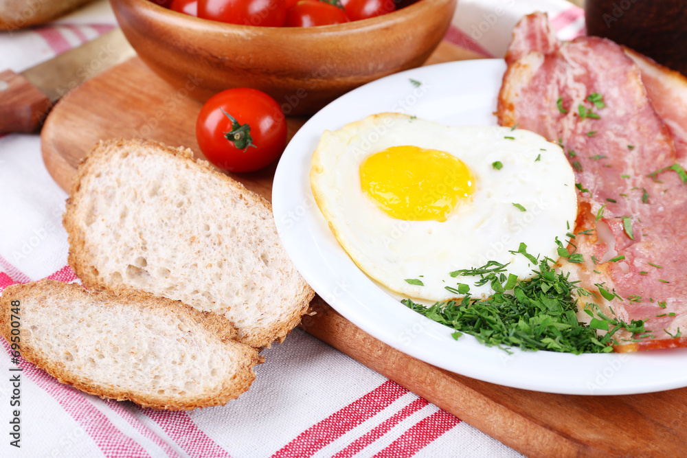 Scrambled eggs with bacon and vegetables served Scrambled eggs with bacon and vegetables served