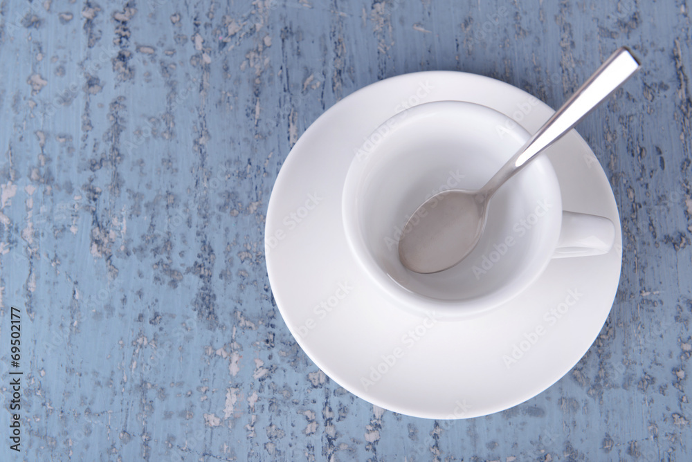 Empty cup with tea spoon on wooden background Empty cup with tea spoon on wooden background