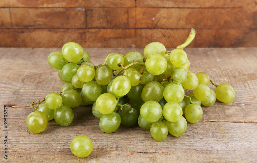 Green grape on wooden table on wooden background Green grape on wooden table on wooden background