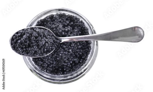 Glass jar and spoon of black caviar isolated on white