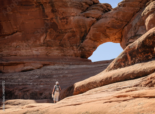 Young woman standing against stone in National Park Arches.