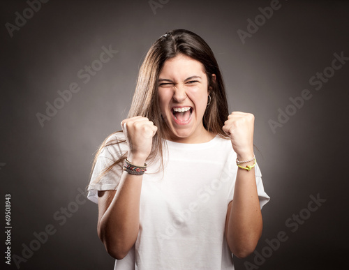 portrait of a young woman celebrating being a winner