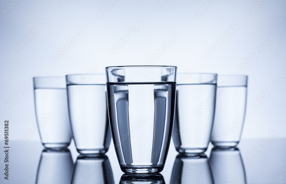 group of glasses filled with water on white background group of glasses filled with water on white background